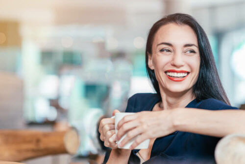 Beautiful young woman with tea smiling