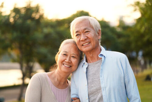 senior couple outdoors and smiling