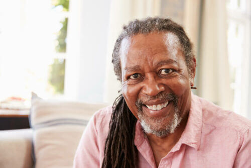 Senior man with long hair and smiling